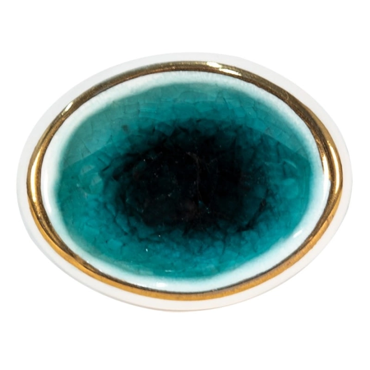 Owalna gałka ceramiczna Emerald z turkusowym, spękanym szkliwem i złotą obwódką.